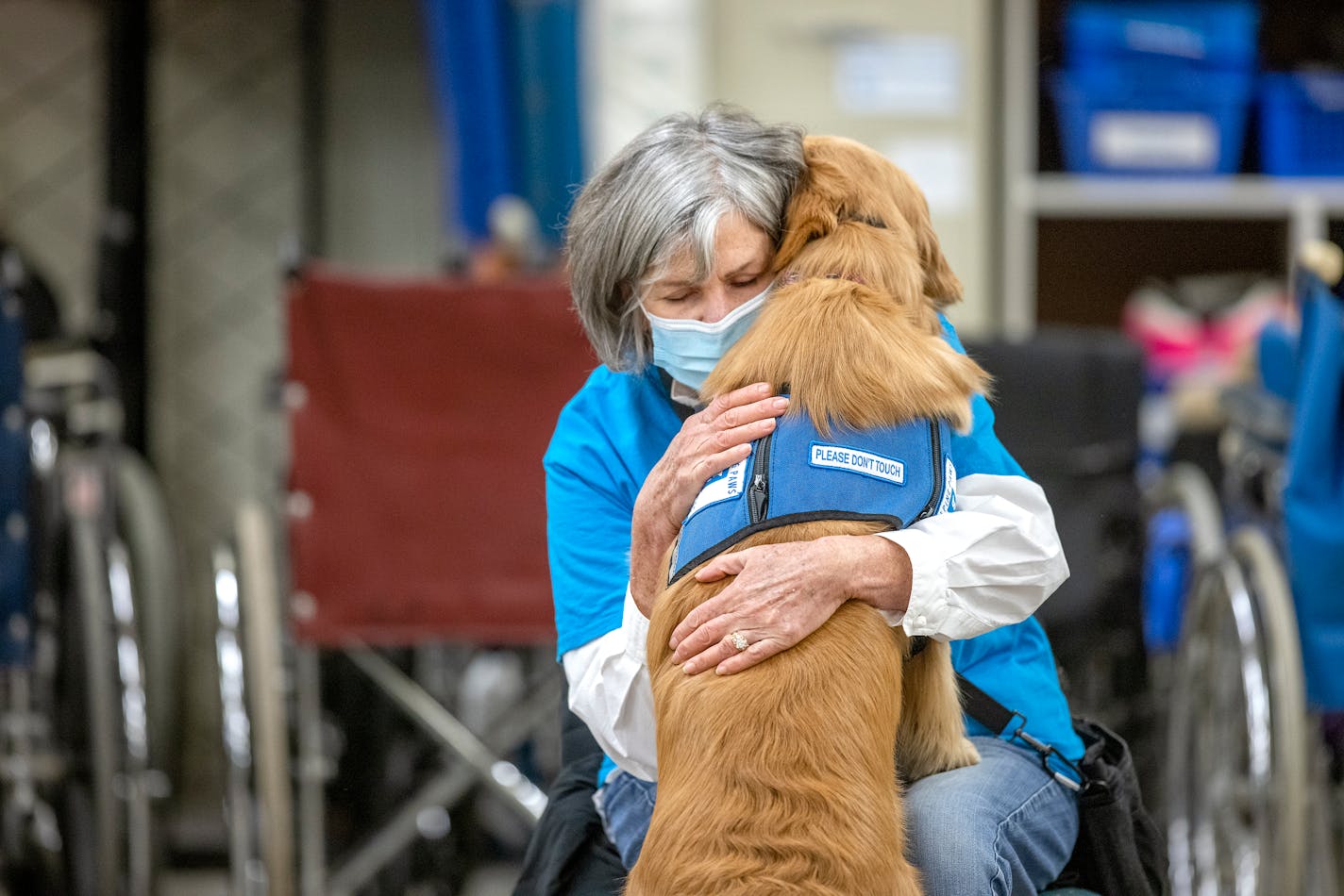 Lorrie Kantar receives a hug from her dog "Emerson," at "Helping Paws of Minnesota" for a live demonstration for visitors, in Hopkins, Minn., on Thursday, November 18, 2021. "Helping Paws of Minnesota" held the event as part of Thursday's annual Give to the Max Day in Minnesota, hoping to raise $50,000. The nonprofit breeds, trains and places assistance dogs with people who have physical disabilities, veterans and first responders. ] Elizabeth Flores • liz.flores@startribune.com