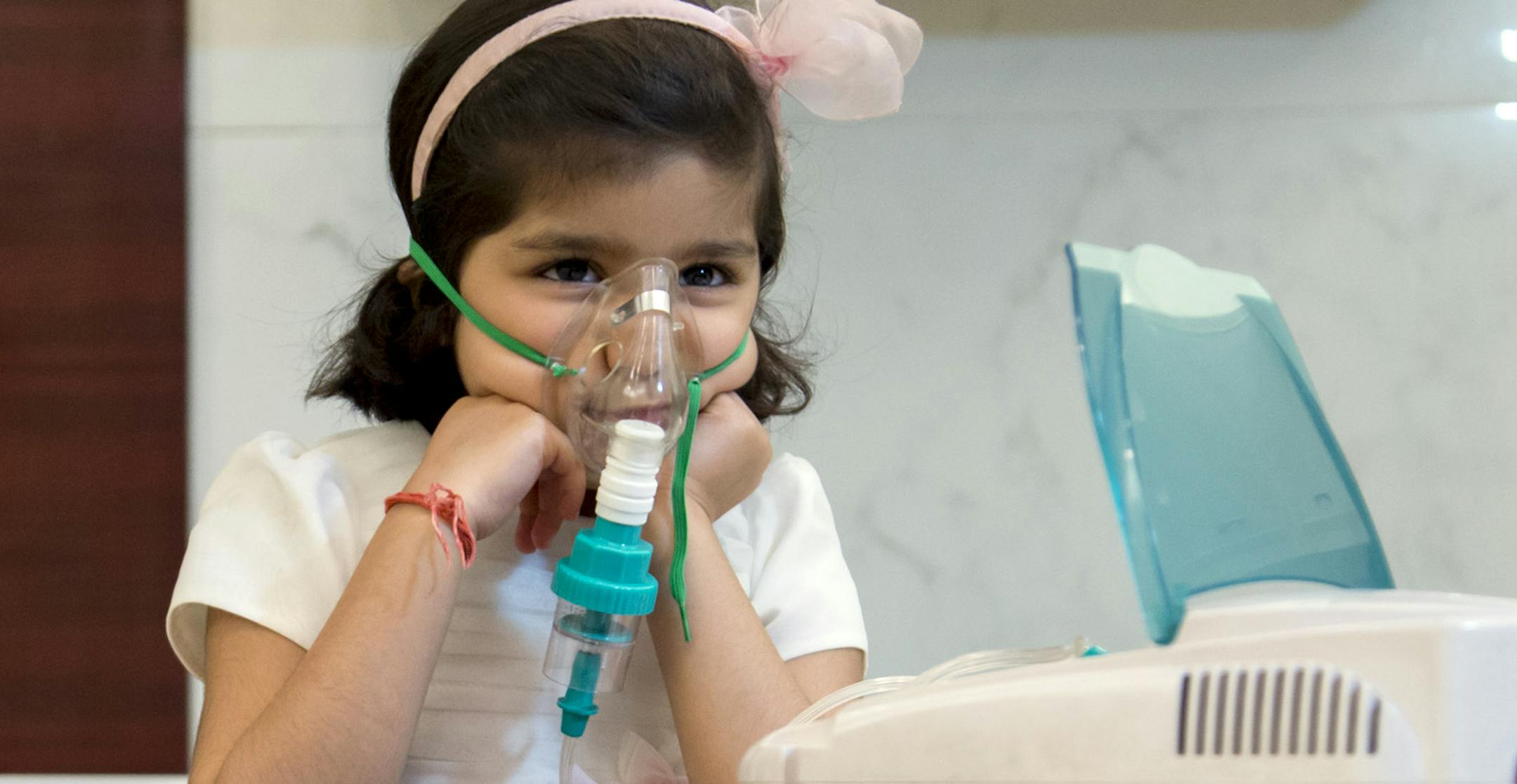 Amanat Devi Jain, 4, who her father says breathes normally outside of India, receives one of her twice-daily breathing treatments for her asthma in New Delhi, Jan. 21, 2014. Researchers suspect that India’s unusual mix of polluted air, poor sanitation and contaminated water may make the country among the most dangerous in the world for lungs.(Graham Crouch/The New York Times)