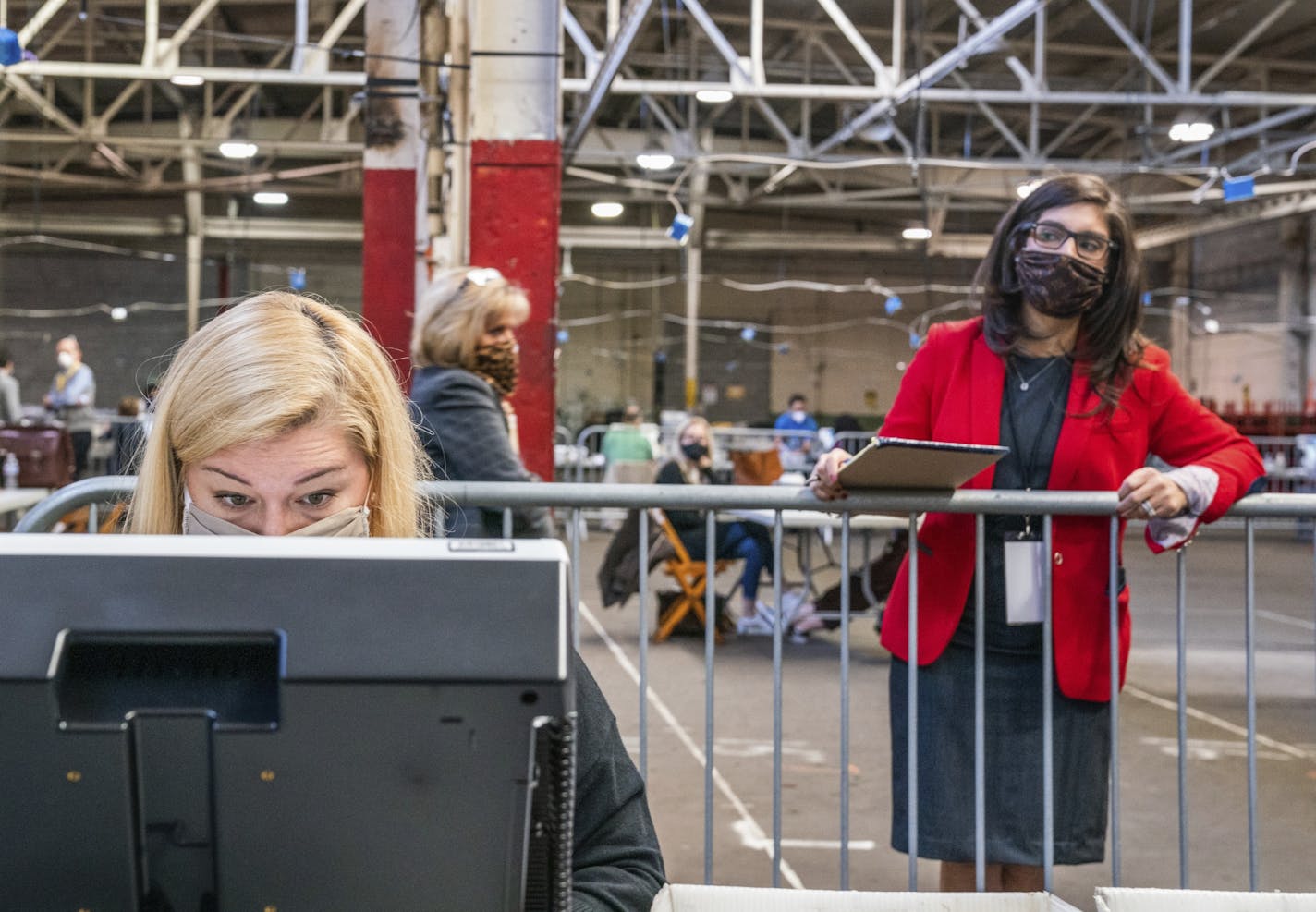 An election watcher observes an Allegheny County Return Board's counting of the remaining absentee and mail-in ballots on Friday, Nov. 6, 2020, in Pittsburgh.