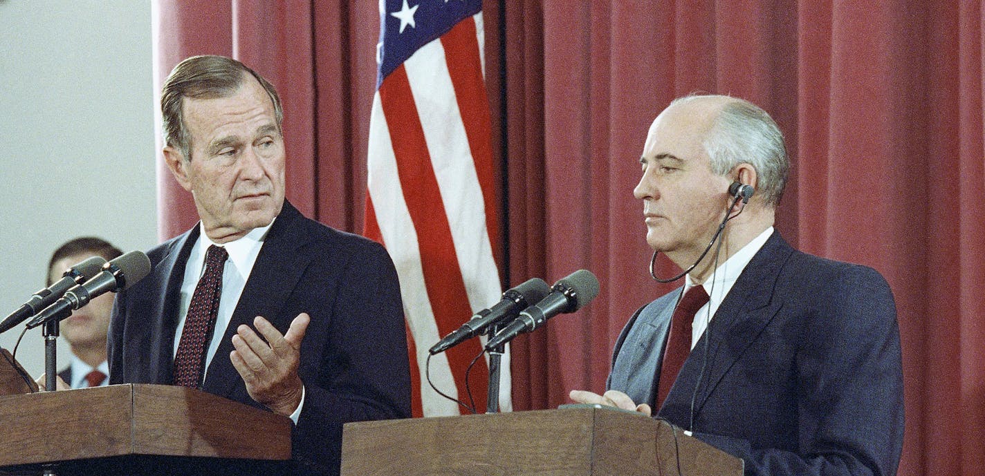 FILE - In this Oct. 29, 1991, file photo, President George H.W. Bush gestures during a joint news conference with Soviet President Mikhail Gorbachev, at the Soviet Embassy in Madrid. Bush died at the age of 94 on Friday, Nov. 30, 2018, about eight months after the death of his wife, Barbara Bush. (AP Photo/Jerome Delay, File)