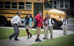 Mastery School students make their way off the school bus in August at a Minneapolis charter school that's part of the Harvest Network.