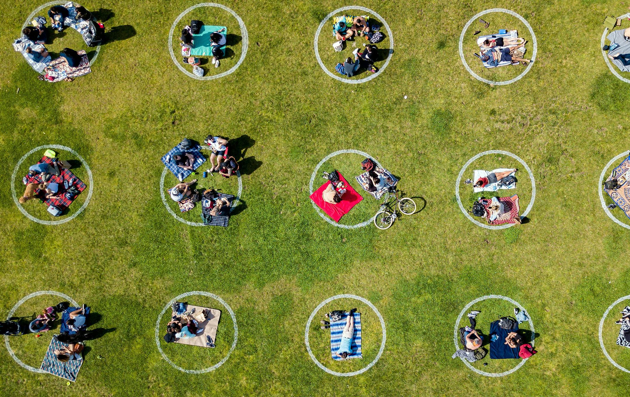 An aerial view shows people gathered inside painted circles on the grass encouraging social distancing at Dolores Park in San Francisco, California on May 22, 2020 amid the novel coronavirus pandemic. (Josh Edelson/AFP/Getty Images/TNS) ORG XMIT: 1725671