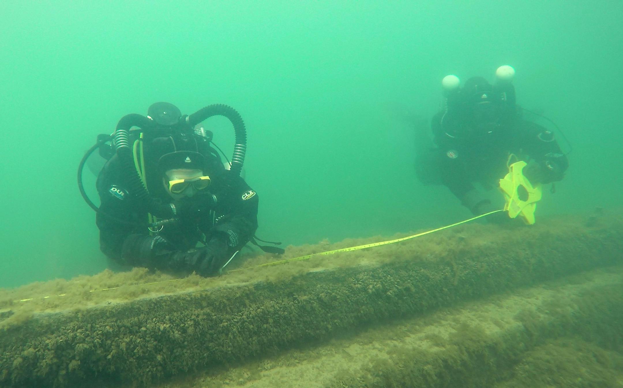 Maritime archaeologists and volunteers from the Wisconsin Historical Society measure the keelson during a survey in Lake Michigan near Port Washington, Wis. on Wednesday, Aug. 9, 2017 at the underwater site of the J.M. Allmendinger, sunk in 1895 while carrying a load of lumber. The site and dozens of other shipwrecks would be protected under a proposed national marine sanctuary for Lake Michigan. (Chris Walker/Chicago Tribune/TNS)