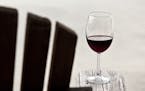 Glass of red wine on an adirondack chair. Istockphoto.com