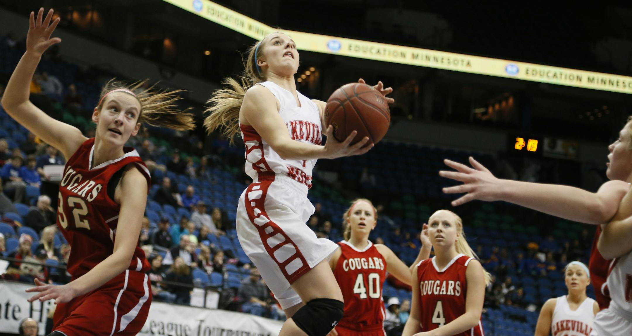 Temi Carda of Lakeville North scored a basket over Jasmin Bretoi during 4-A girls quarter final action at Target Center between Centennial and Lakeville North Tuesday March 18, 2014 in Minneapolis .MN ] JERRY HOLT jerry.holt@startribune.com