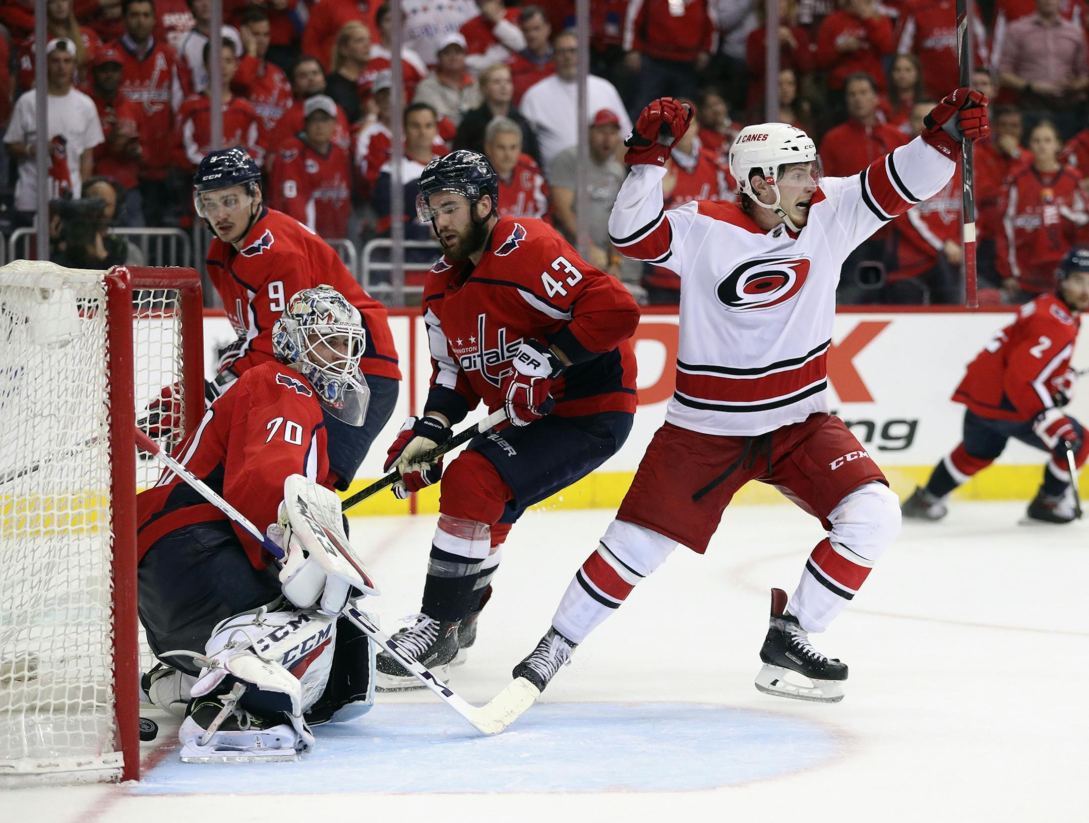 Brock McGinn, right, of the Carolina Hurricanes scores the game-winning goal against Braden Holtby of the Washington Capitals at 11:05 of the second overime period in Game 7 of the Eastern Conference first-round playoff series at the Capital One Arena in Washington, D.C., on Wednesday, April 24, 2019. The Hurricanes advanced with a 4-3 win in double OT. (Patrick Smith/Getty Images/TNS) **FOR USE WITH THIS STORY ONLY**