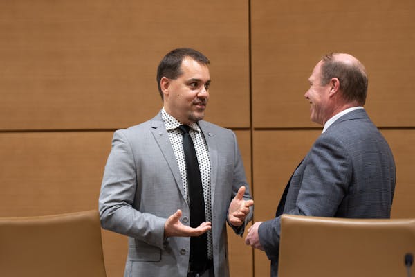 Sen. Eric Lucero, R-St. Michael, left, talked with Sen. Jason Rarick, R-Pine City, in a Senate committee room at the State Capitol on Wednesday.