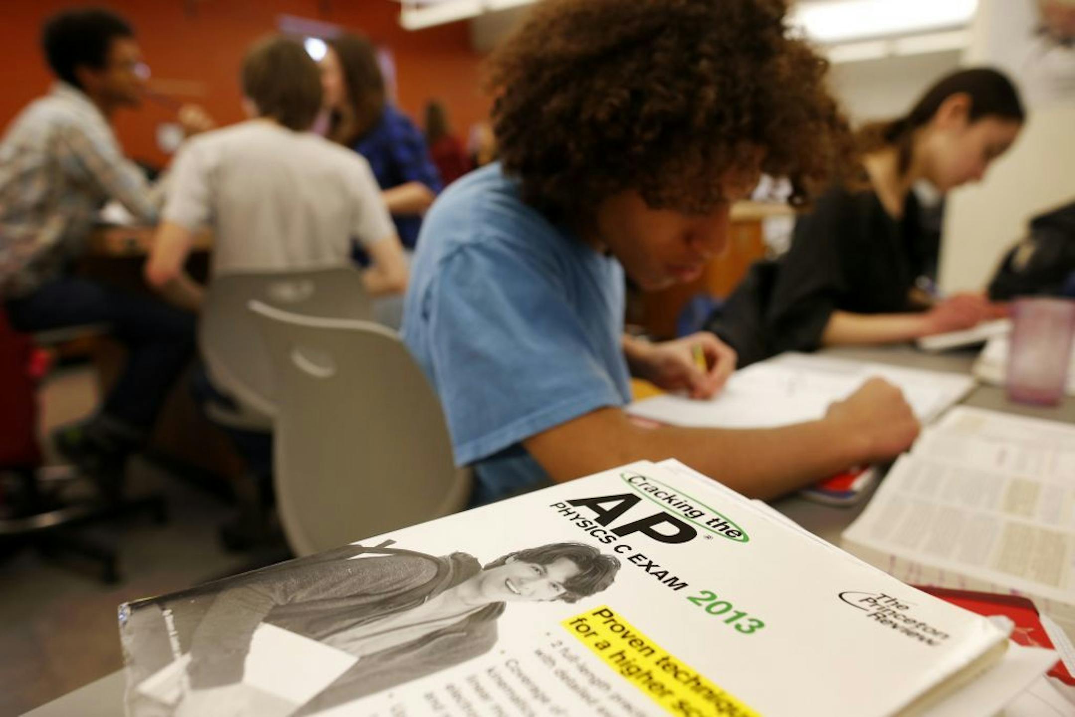 Twelfth grade students Sohrab Pasikhani, left, and Bridgette LaFaye work in their Advanced Placement (AP) Physics class at Woodrow Wilson High School in Washington, Friday, Feb. 7, 2014. The College Board says in a new report that the number of U.S. public students taking Advanced Placement classes doubled over the last decade. The class of 2013 of took 3.2 million AP exams.