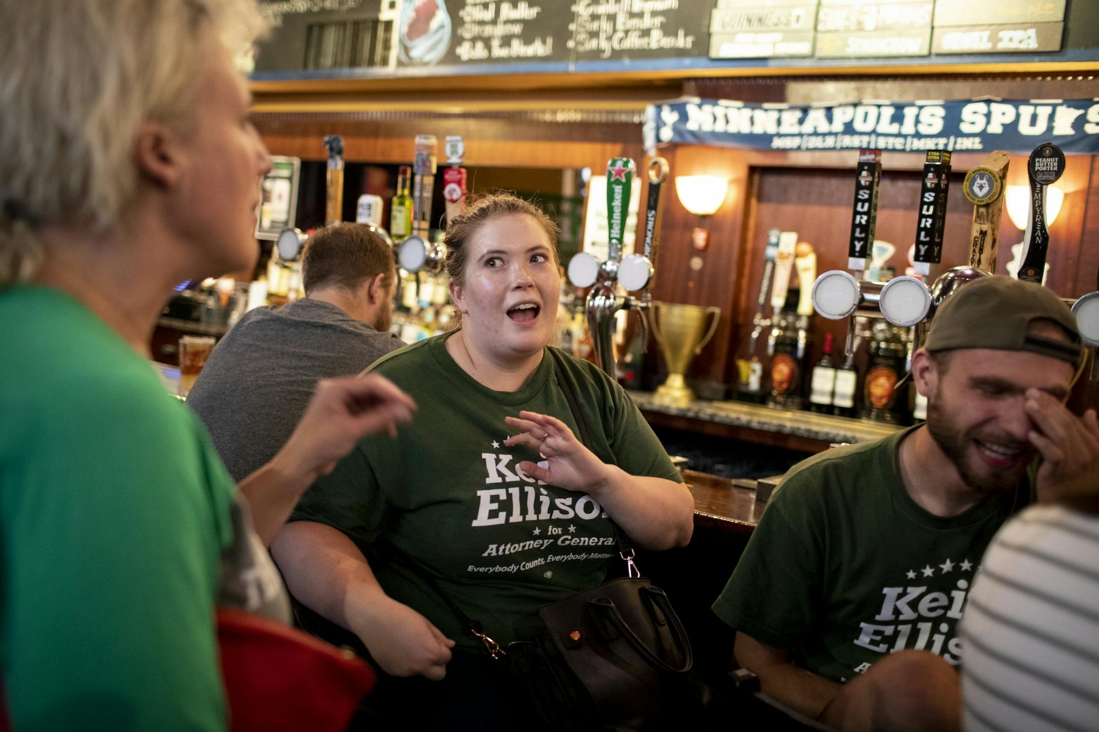 From the left; Sarah Helgen, with the Keith Ellison campaign, Natalie Anderson and Danny Knigge, both interns with the campaign, got to know each other as they waited for results at the Ellison campaign party at Nomad World Pub in Minneapolis, Minn., on August 14, 2018.