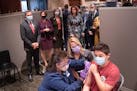 Department of Health and Human Services HHS Secretary Xavier Becerra, left, watched, along with U.S. Sen. Amy Klobuchar, Rochester Mayor Kim Norton an