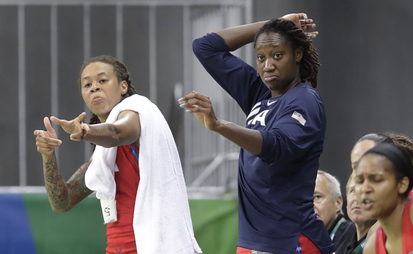 United States forward Seimone Augustus, left, and center Tina Charles go through an arrow shooting ritual after a teammate's three-point basket during the second half of a women's basketball game at the Youth Center at the 2016 Summer Olympics in Rio de Janeiro, Brazil, Sunday, Aug. 14, 2016. The United States defeated China 105-62. (AP Photo/Carlos Osorio)