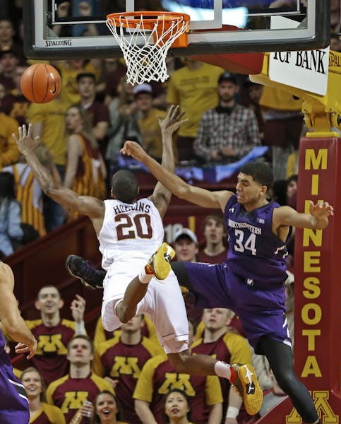 Minnesota's Austin Hollins was fouled by Northwestern's Sanjay Lumpkin as he drove to the basket in first half action.