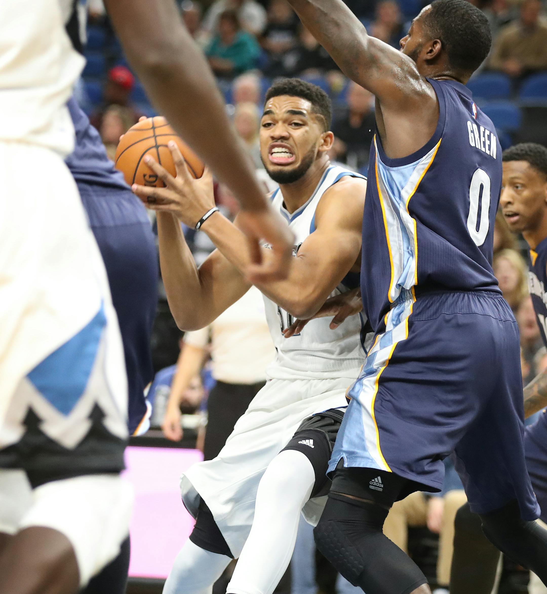 Minnesota Timberwolves forward Karl-Anthony Towns (32) looks for a pass through the defense of Memphis Grizzlies forward JaMychal Green (0) during the first half. ] (Leila Navidi/Star Tribune) leila.navidi@startribune.com BACKGROUND INFORMATION: The Minnesota Timberwolves play the Memphis Grizzlies at Target Center in Minneapolis on Tuesday, November 1, 2016.