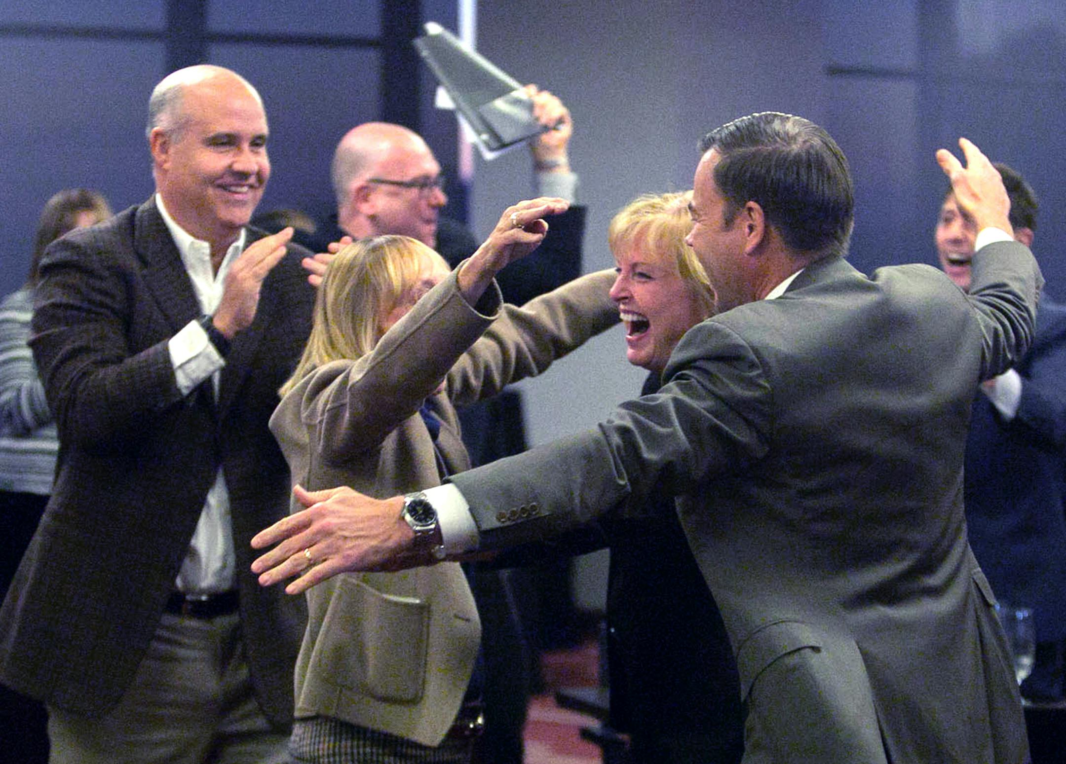 Mary Brainerd, president and CEO of HealthPartners, Inc. and Minnesota Final Four Bid Committee co-chair, in middle, is swarmed by other committee members Friday at the momnet Minneapolis was selected to hold the 2019 Final four Basketball tournamnet. other members are, David Mortenson, center, president of Mortenson Construction and Minnesota Final Four Bid Committee co-chair, far left, Norwood Teague, director of athletics at the University of Minnesota, arm covering her face is, Michele Kelm-