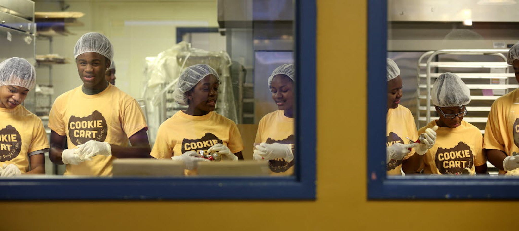 Cookie Cart employees chatted as they scooped cookie dough at the bakery in North Minneapolis. Valentine's Day cookies may be ordered through Feb. 13.