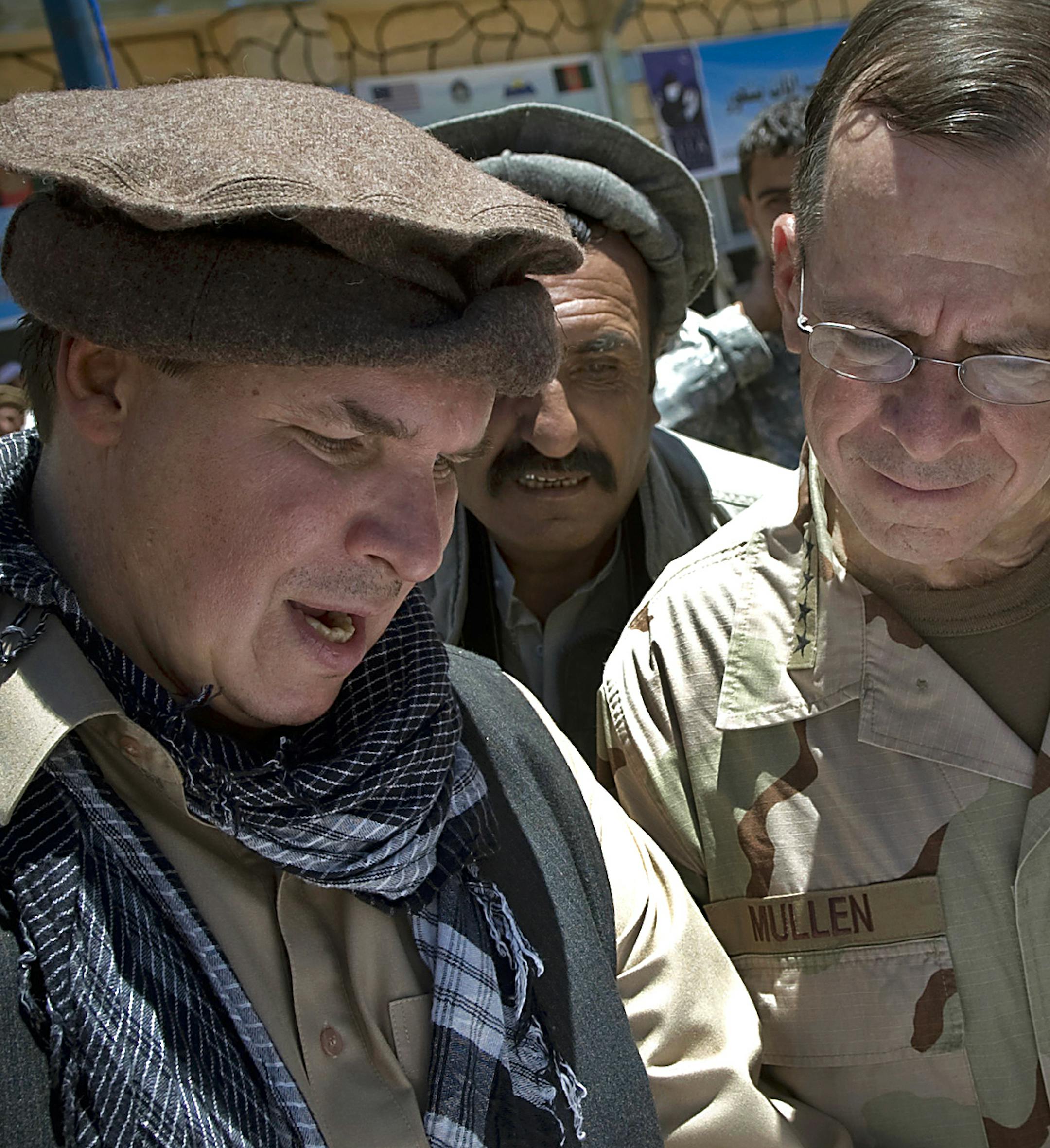 FILE - In this July 15, 2009 file photo released by Department of Defense, ìThree Cups of Teaî co-author Greg Mortenson shows the locations of future village schools to U.S. Navy Adm. Mike Mullen, chairman of the Joint Chiefs of Staff, at the opening of Pushghar Village Girls School 60 miles north of Kabul in Panjshir Valley, Afghanistan. Montanaís attorney general on Tuesday, April 19, 2011 told The Associated Press that he has launched an inquiry into the charity run by Mortenso