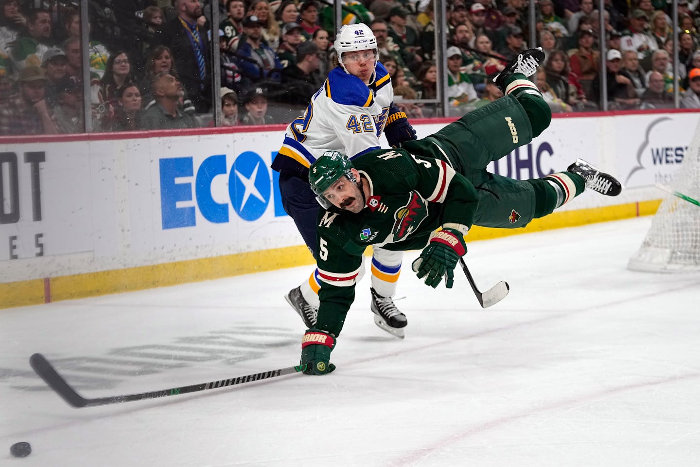 Wild defenseman Jake Middleton falls while reaching for the puck against St. Louis Blues right wing Kasperi Kapanen during the second period Saturday