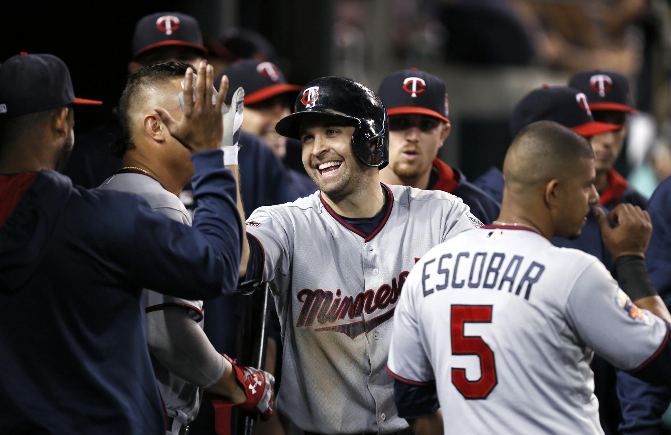 Minnesota Twins second baseman Brian Dozier celebrates his solo home run against the Detroit Tigers in the third inning of a baseball game in Detroit, Friday, Sept. 26, 2014.