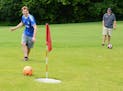 In a round of footgolf at Inver Wood Golf Course in Inver Grove Heights, Elliott Gonsioroski kicked the ball just shy of the cup as Sam Nord watched.