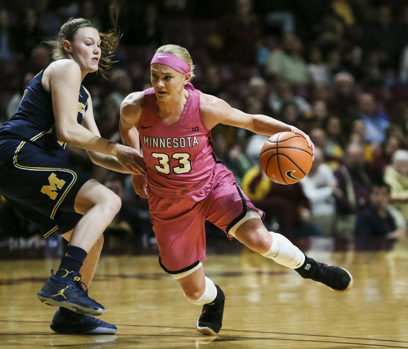 Gophers guard Carlie Wagner dribbled past Wolverines guard Nicole Munger in the first half.