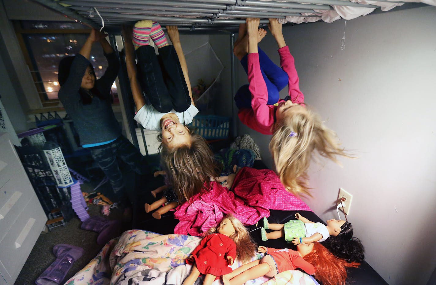 Elizabeth Goodsky, left, and her sister Alexis Goodsky played on their bunk beds with dolls at their home in Duluth.