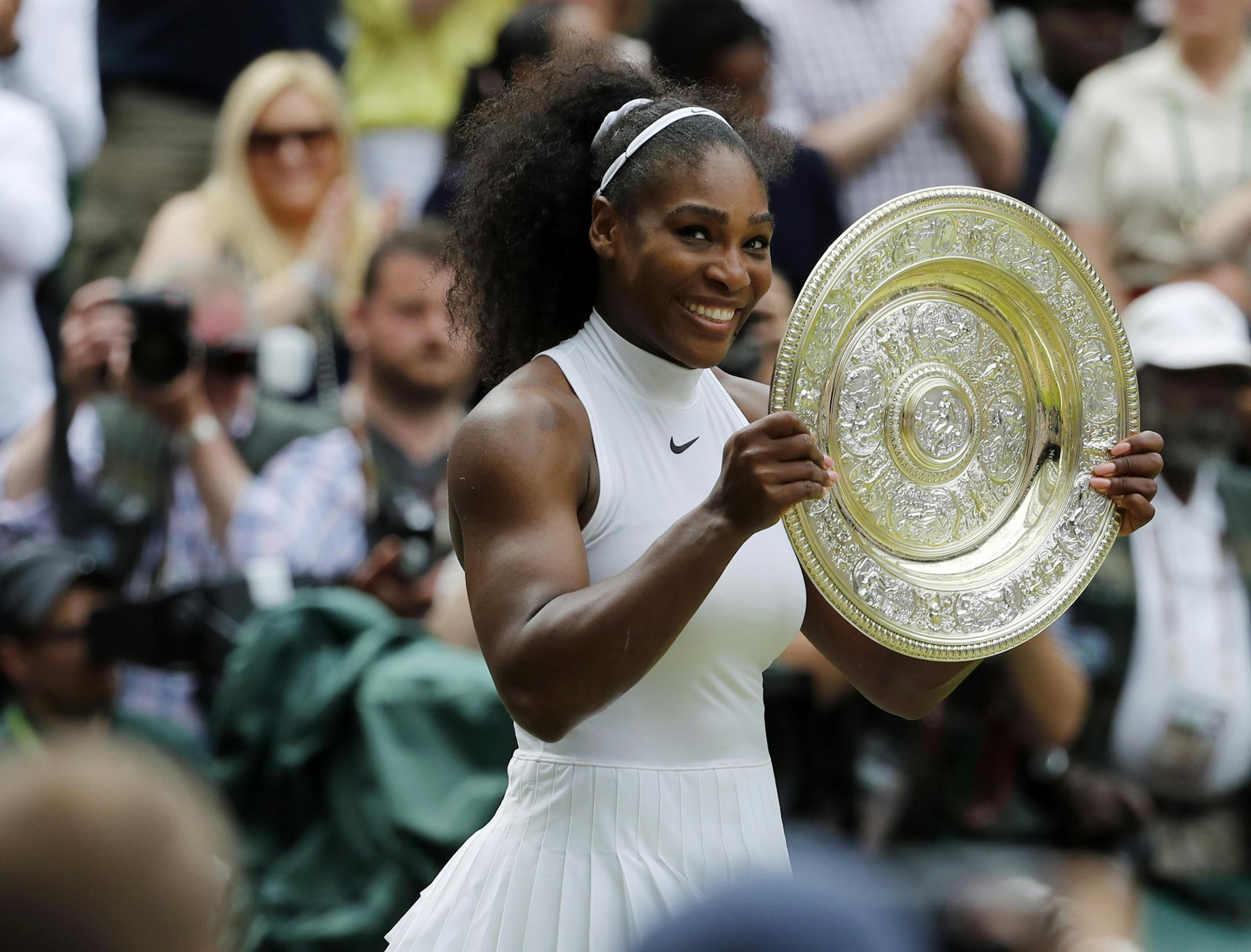 FILE - In this Saturday, July 9, 2016 file photo, Serena Williams of the U.S holds her trophy after winning the women's singles final against Angelique Kerber of Germany on day thirteen of the Wimbledon Tennis Championships in London. Williams has been seeded 25th for the women's singles tournament at Wimbledon, the All England Club announced Wednesday, June 27, 2018. The 36-year-old American, who has returned to competitive tennis following the birth of her daughter last September, is currently