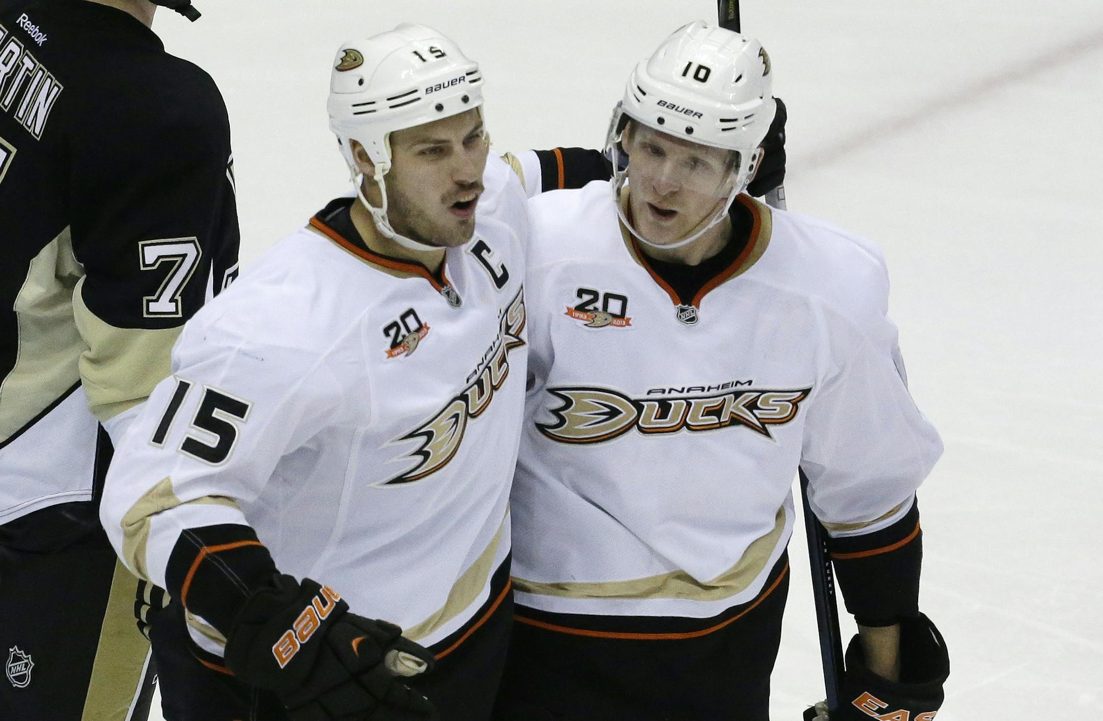 Anaheim Ducks' Ryan Getzlaf (15) celebrates his third-period goal with teammate Corey Perry (10) during an NHL hockey game against the Pittsburgh Penguins in Pittsburgh Monday, Nov. 18, 2013. The Penguins won 3-1. (AP Photo/Gene J. Puskar) ORG XMIT: PAGP114