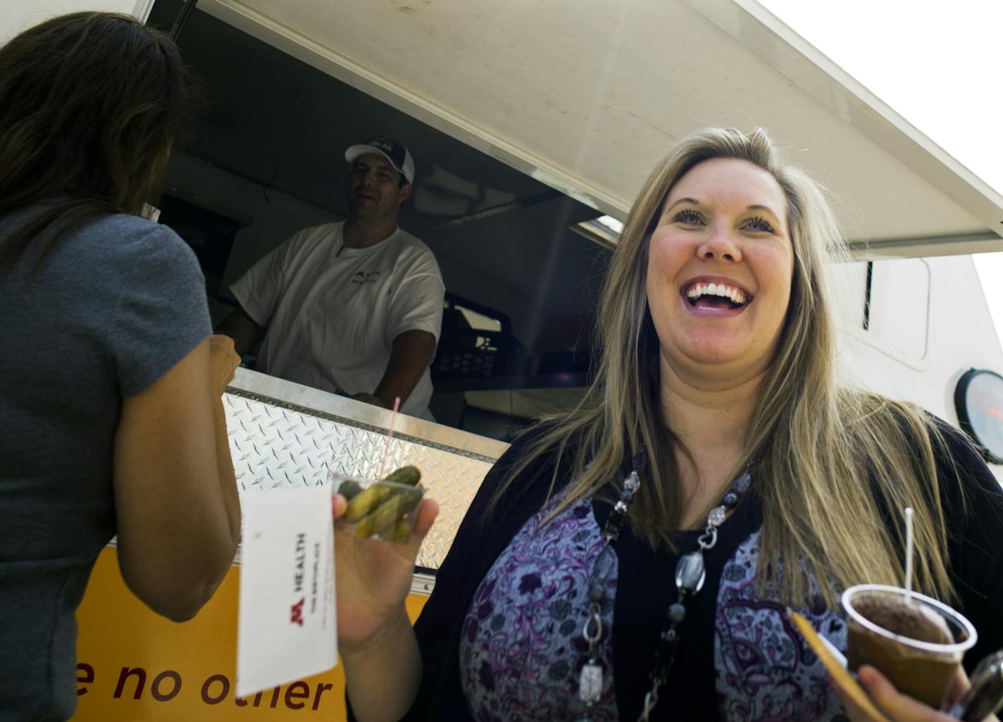 Melissa Berends, who is 19 weeks pregnant, visited the Pickles & Ice Cream food truck that came to Maple Grove to market the University of Minnesota Medical Center&#x2019;s revamped maternity ward. At left is co-worker Connie Nelson.