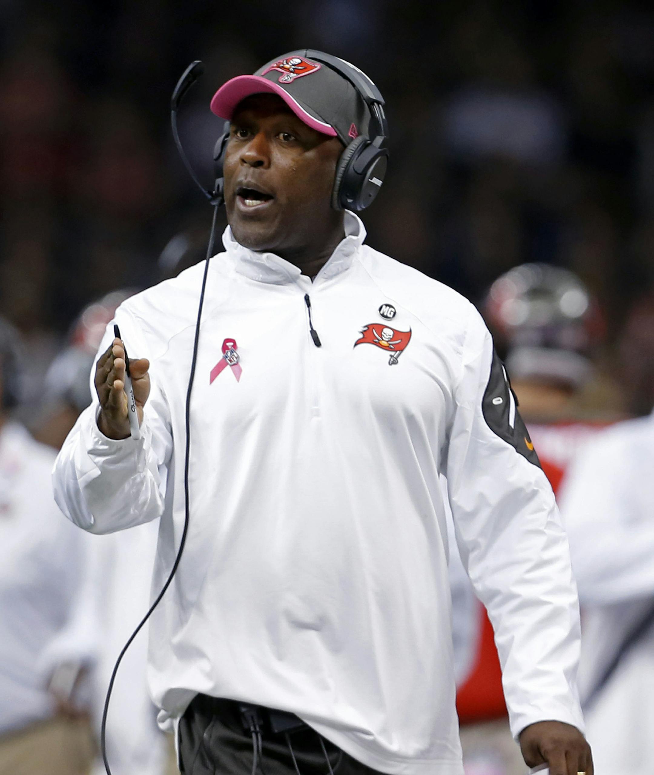 Tampa Bay Buccaneers head coach Lovie Smith calls from the sideline in the first half of an NFL football game against the New Orleans Saints in New Orleans, Sunday, Oct. 5, 2014. (AP Photo/Jonathan Bachman)