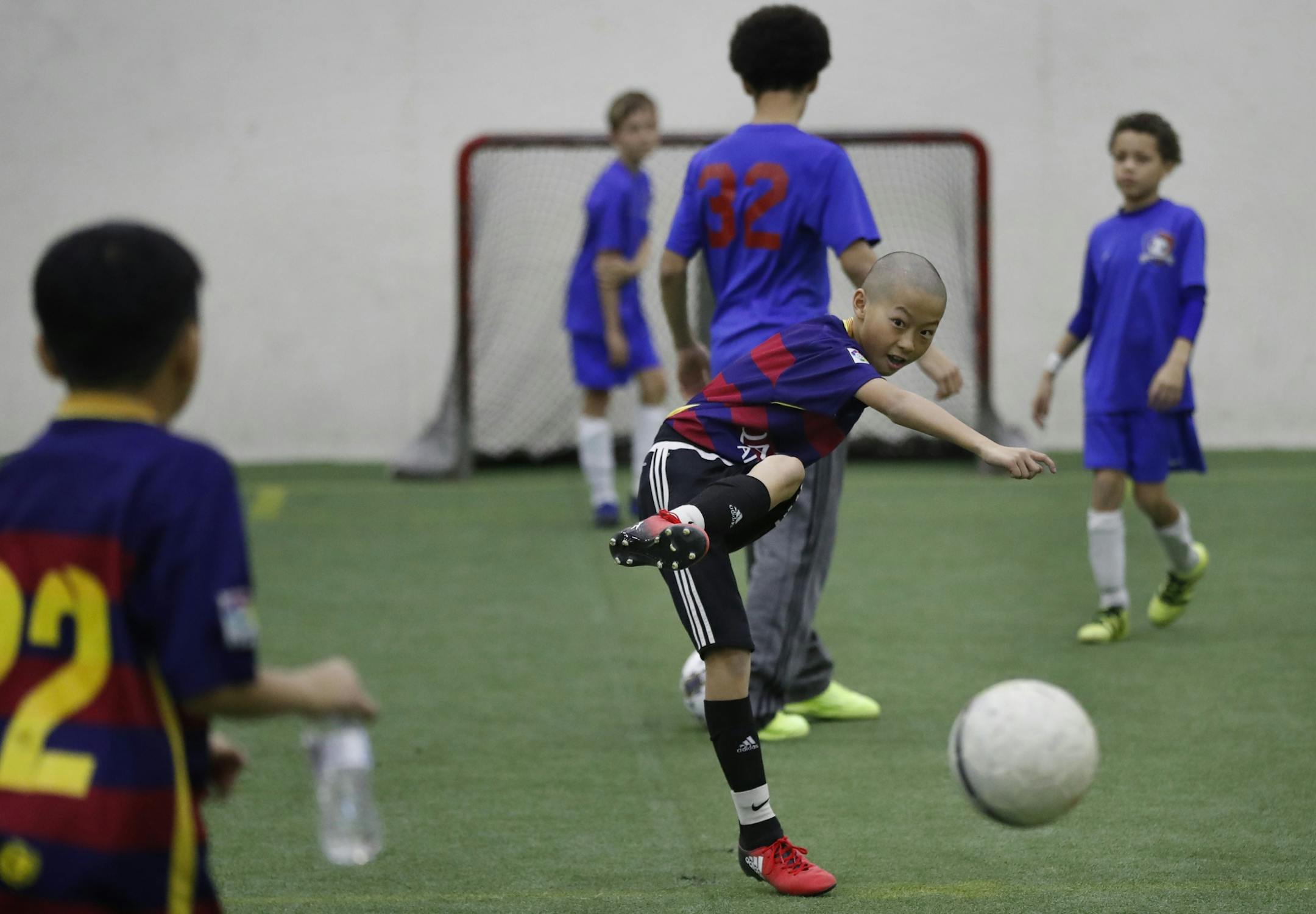 Kenji Moua (center) of the Generation X soccer team warmed up with his 11u/12u team game at the National Sports Center Sunday February 19, 2017 in Blaine, MN.