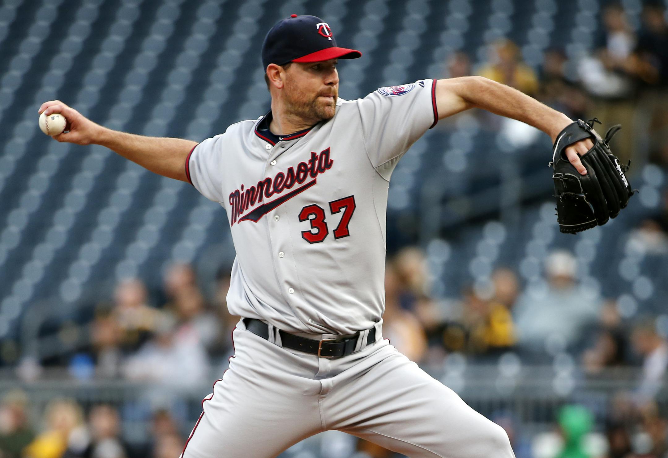 Minnesota Twins starting pitcher Mike Pelfrey (37) delivers during the first inning of a baseball game against the Pittsburgh Pirates in Pittsburgh, Wednesday, May 20, 2015. (AP Photo/Gene J. Puskar)