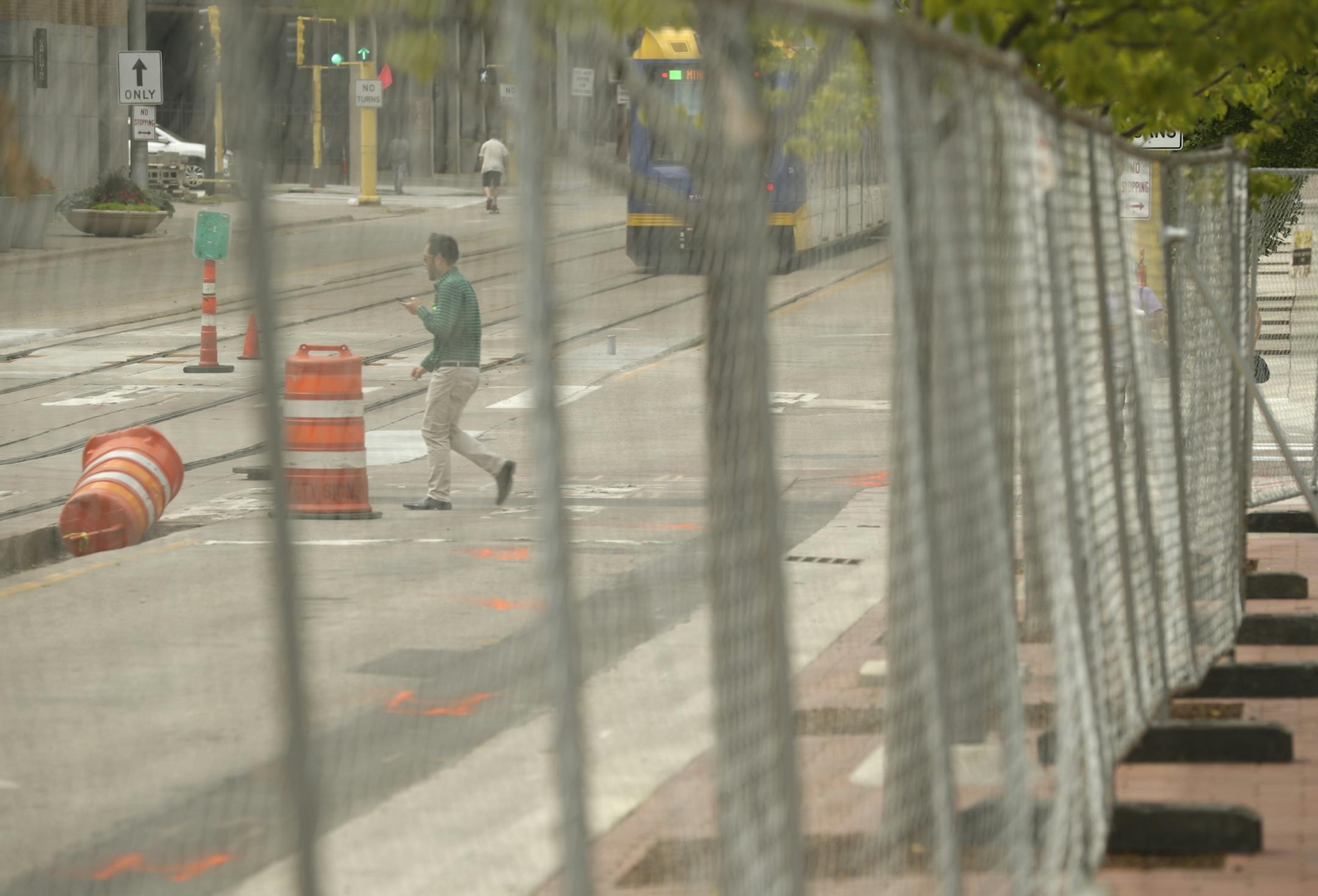 Chain link fencing surrounds The Commons Park across from U.S. Bank Stadium.