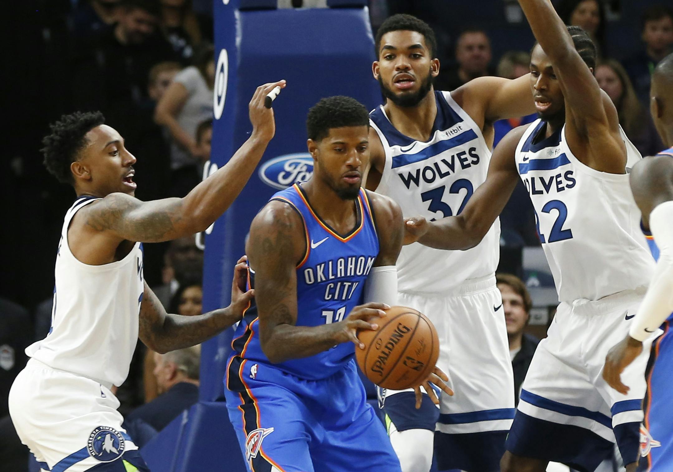 Oklahoma City Thunder's Paul George found himself surrounded by the Timberwolves, from left, Jeff Teague, Karl-Anthony Towns and Andrew Wiggins on Friday night.