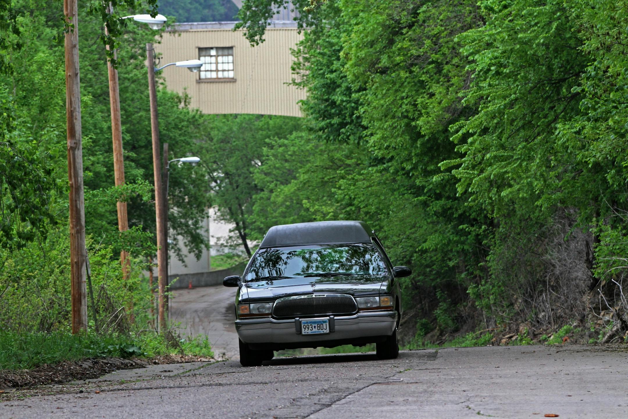 A hearse containing the body of a person recovered from the Mississipi River near the Ford Power plant left the area Tuesday morning on 5/21/13.