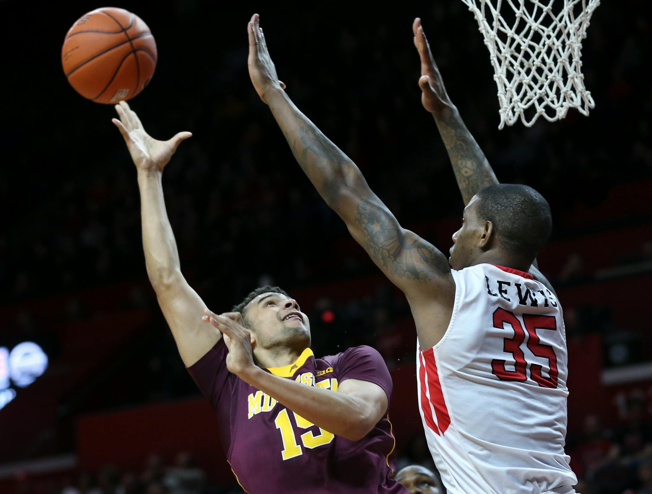 Minnesota forward Stephon Sharp (15) takes a shot as Rutgers forward Greg Lewis (35) tries to block his path during the first half of an NCAA college basketball game Saturday, March 5, 2016, in Piscataway, N.J. (AP Photo/Mel Evans)