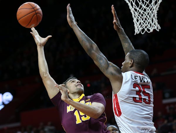 Minnesota forward Stephon Sharp (15) takes a shot as Rutgers forward Greg Lewis (35) tries to block his path during the first half of an NCAA college 