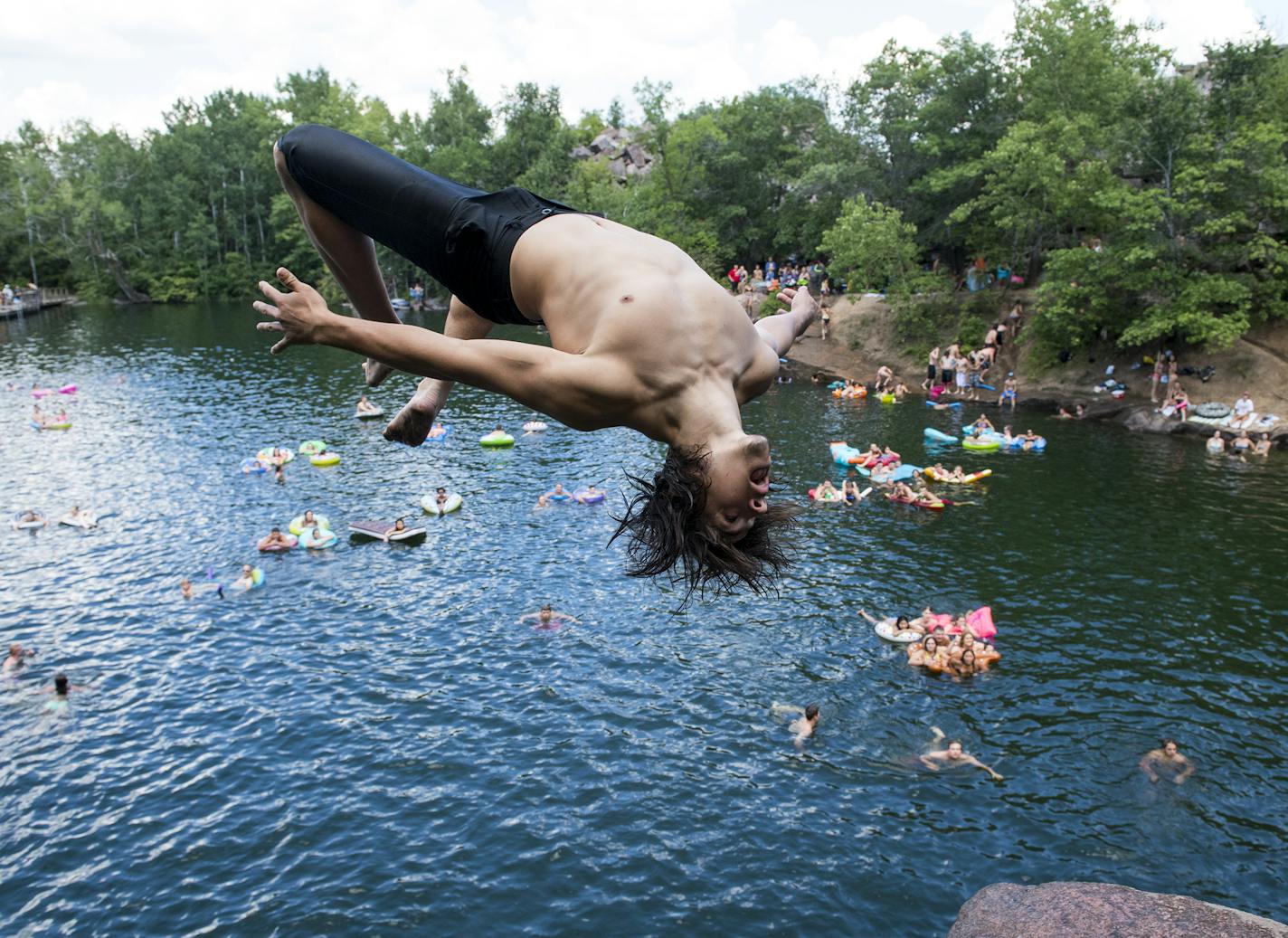 Mason Schmitt, of Maple Grove, did a flip off a cliff at quarry number 2 at Quarry Park and Nature Reserve on Saturday. ] Isaac Hale &#x2022; isaac.hale@startribune.com People took to the swimming holes at Quarry Park and Nature Reserve in St. Cloud, MN, on Saturday, July 30, 2016. One of the more popular areas to swim in Minnesota, the park attracts families as well as teenagers and young adults who jump off some of the cliffs surrounding the waters.