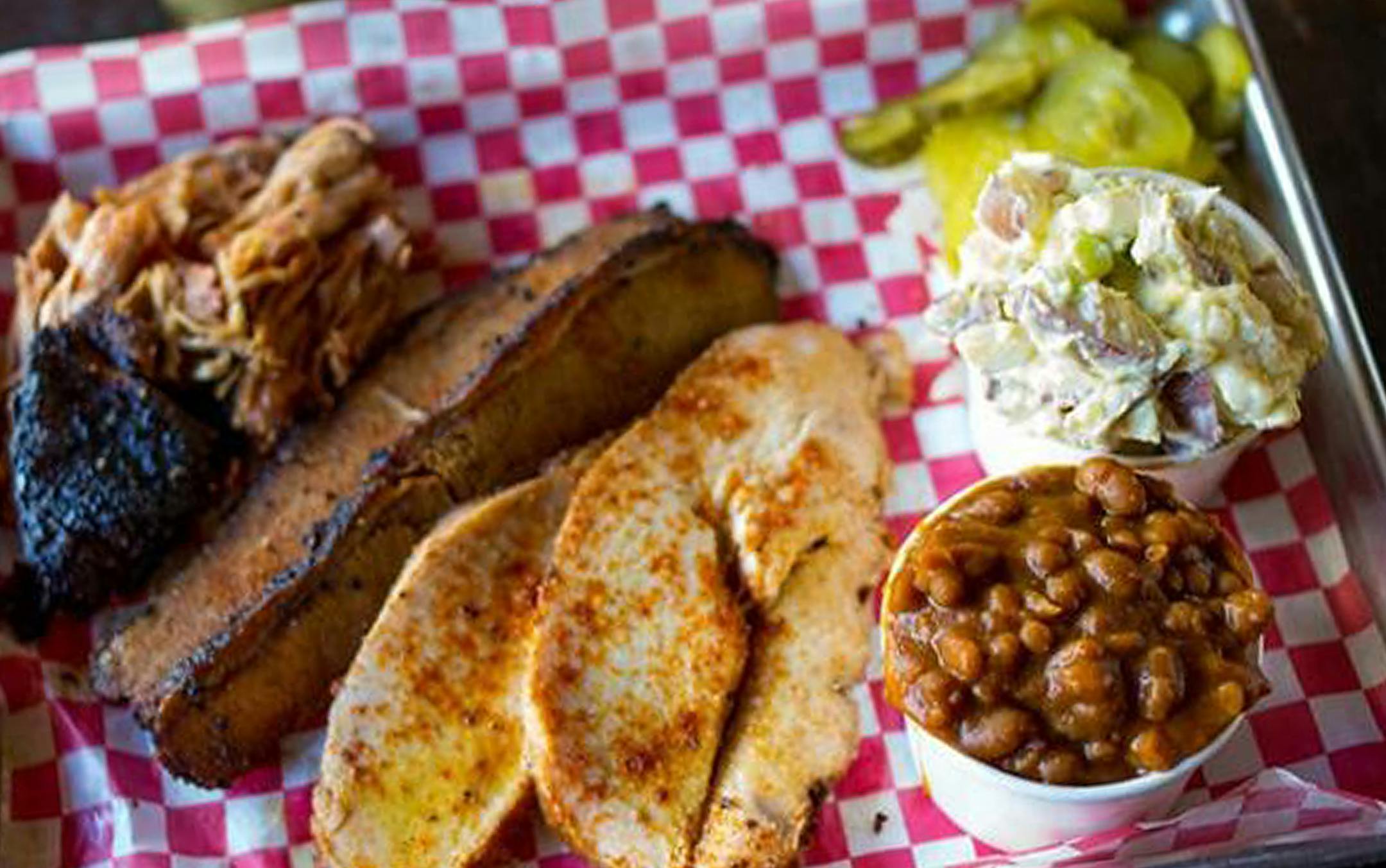 Smoke Tree BbíQ shows our 3 meat combo of Carolina pulled pork, Choice angus beef brisket and smoked turkey with our bbq beans and potato salad.