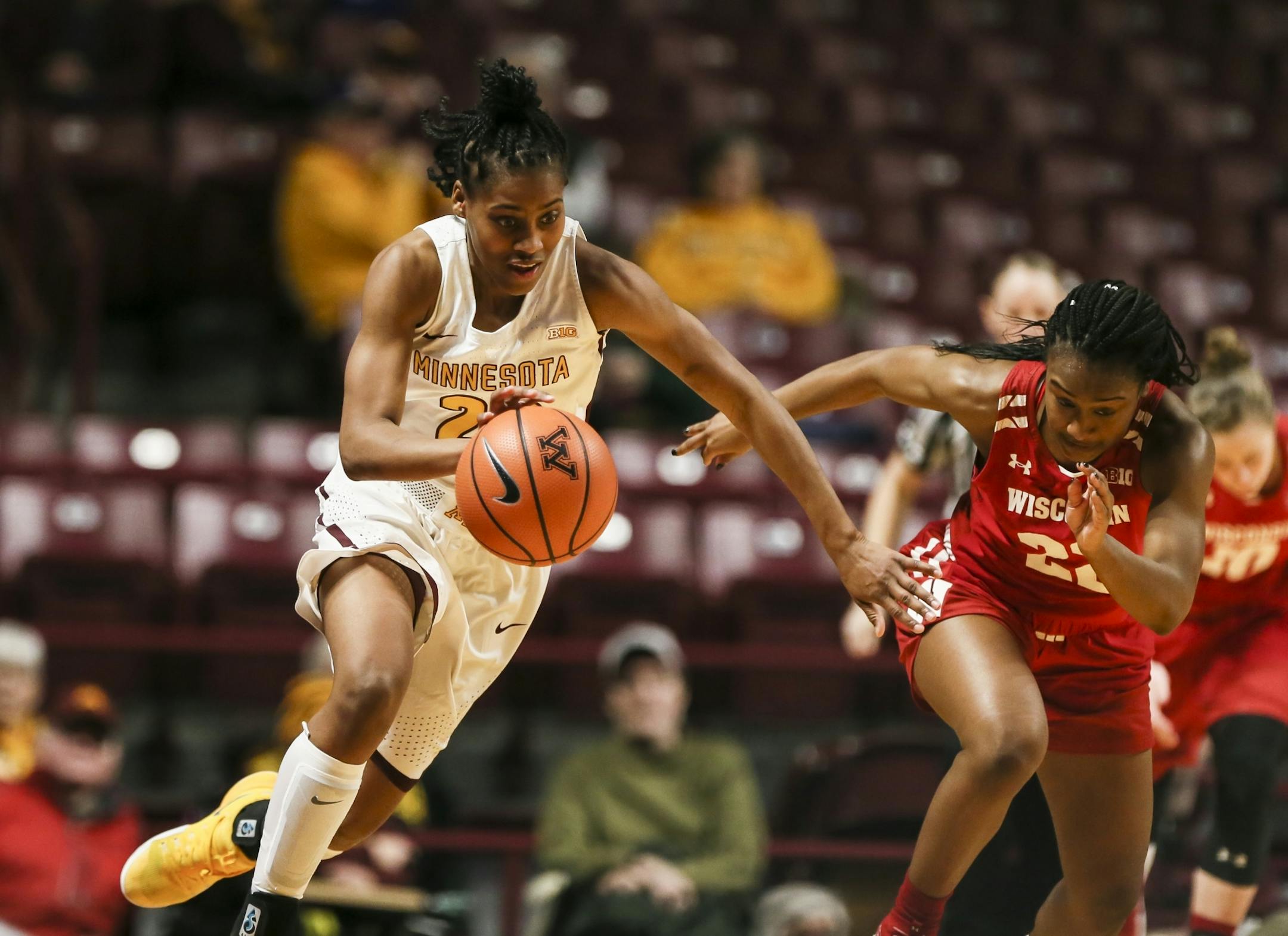 Minnesota Golden Gophers guard Kenisha Bell (23) ran down court after stealing a pass intended for Wisconsin Badgers guard Niya Beverley (22) in the first half.