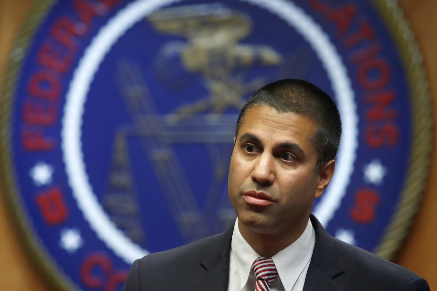 FILE - In this Dec. 14, 2017, file photo, Federal Communications Commission Chairman Ajit Pai arrives for an FCC meeting on net neutrality, in Washington. A group of 22 state attorneys general has sued to block the Federal Communications Commission&#xed;s repeal of net-neutrality rules. These rules barred companies like AT&T, Comcast and Verizon from interfering with internet traffic and favoring their own sites and apps. Pai&#xed;s push to undo them inspired both street and online protests in d