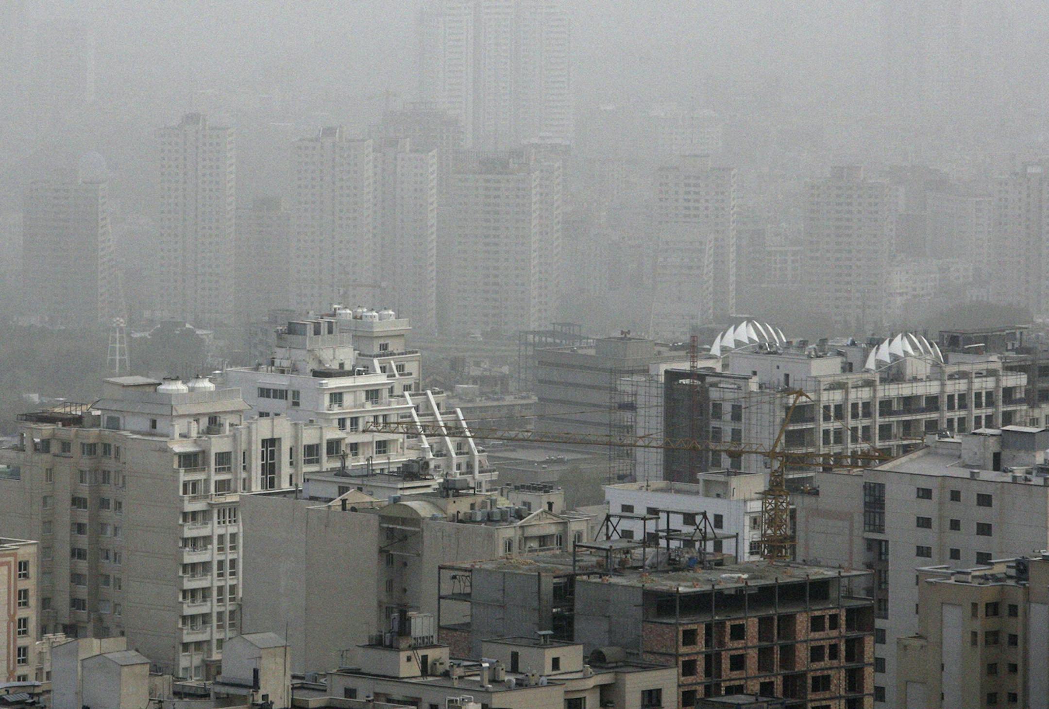 Buildings are seen in a dust storm in Tehran Wednesday, April 13, 2011. A dust storm has engulfed more than half of the country including the capital Tehran. Many flights and schools went out of function, according to reports. (AP Photo/Vahid Salemi) ORG XMIT: VAH102