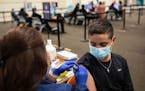 Roman McNelly, 15, received a dose of the Pfizer COVID-19 vaccine at University Health’s vaccine hub at the Wonderland of the Americas shopping cent