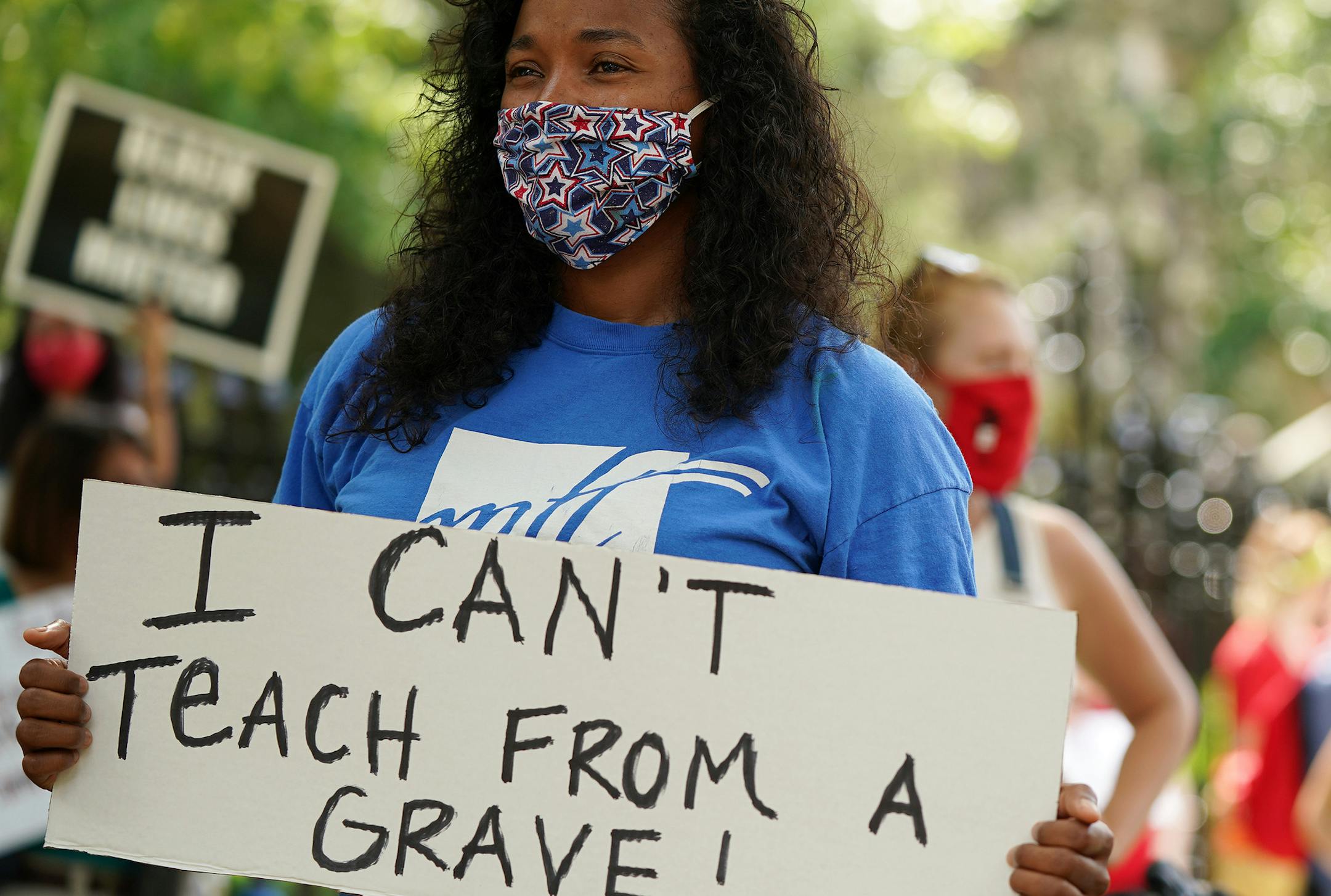 Lindsey West who teaches 5th grade at Clara Barton Open School held a sign as she and others protested in person learning this fall outside in Governor's Residence Friday. ] ANTHONY SOUFFLE • anthony.souffle@startribune.com The Saint Paul Federation of Educators and Minneapolis Federation of Teachers and Education Support Professionals hosted a march, rally and caravan calling for a return to distance learning this fall unless there is a dramatic improvement in the disease-prevention measures in