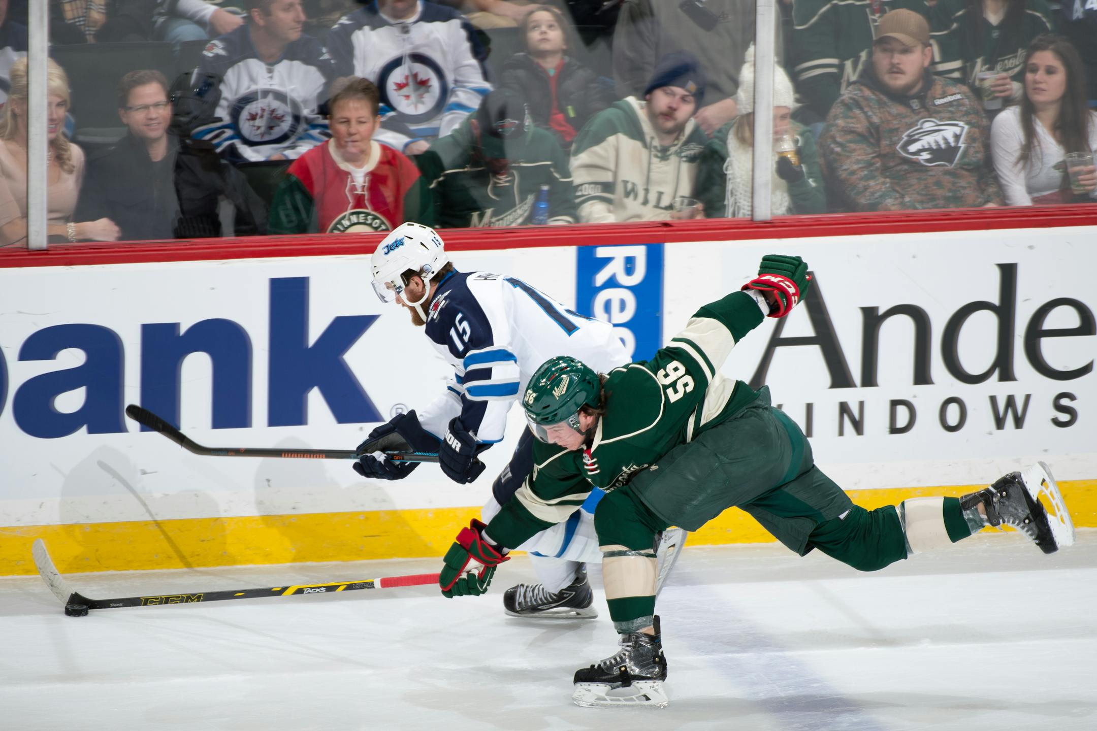 Minnesota Wild left wing Erik Haula (56) goes low for the puck while defending against Winnipeg Jets right wing Matt Halischuk (15) late in the first period. ] AARON LAVINSKY � aaron.lavinsky@startribune.com The Minnesota Wild take on the Winnipeg Jets Saturday, Dec. 27, 2015 at Xcel Energy Center in St. Paul.