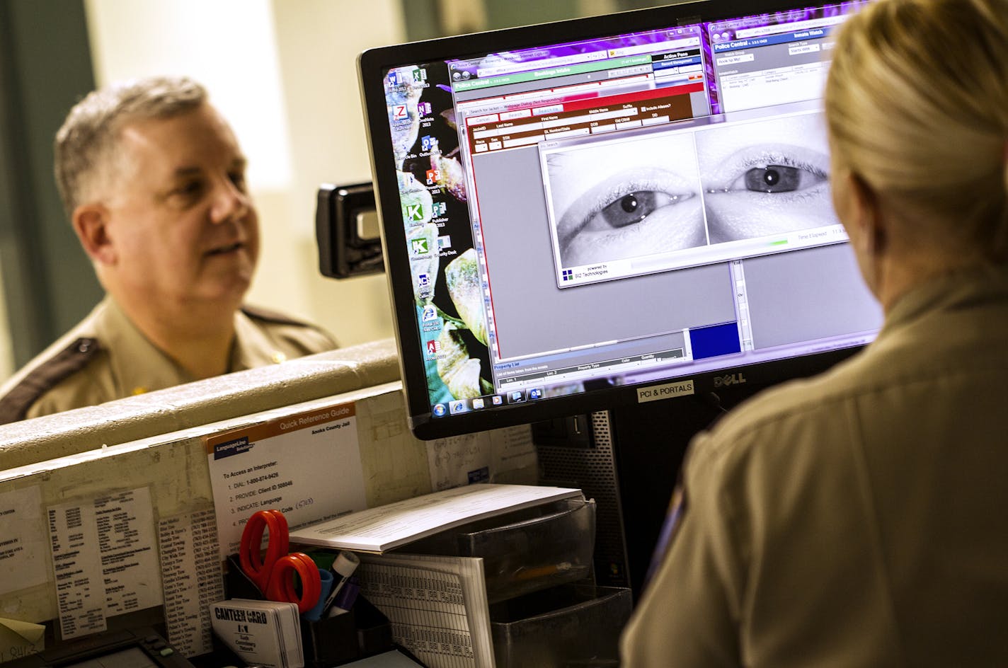 Anoka County jail Cmdr. Dave Pacholl demonstrates how a new iris scanning system works in the release station at the Anoka County Jail. The scan, which is simply a high-quality photograph, takes less time to obtain than fingerprints.