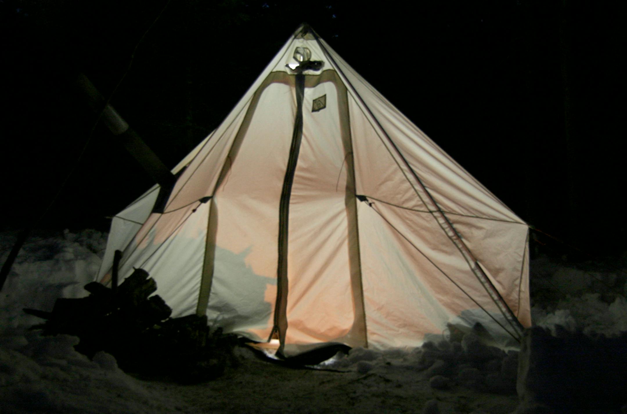 A canvas tent glows at night during a winter camping trip in the BWCA. Doug Smith/Star Tribune