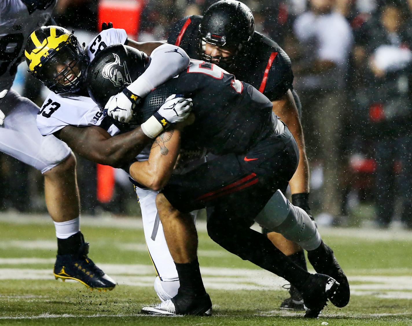 Michigan defensive end Taco Charlton (33) sacks Rutgers quarterback Chris Laviano (5) during the first half last weekend.