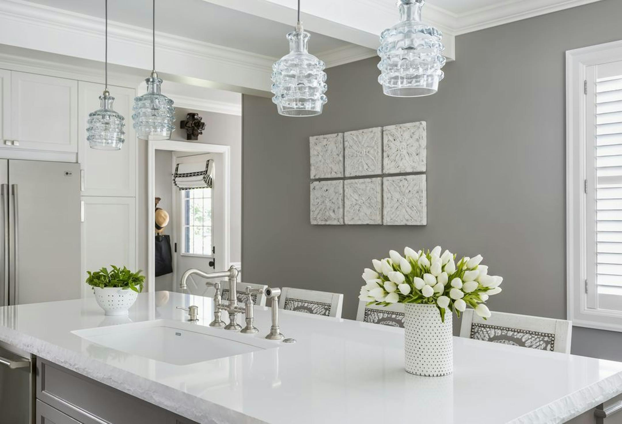 Clear handblown-glass pendants provide task lighting and the ribbon in the pendants gives it texture.