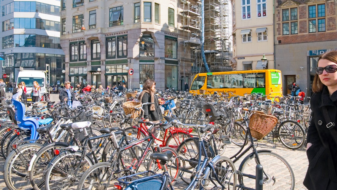 Copenhagen, Denmark - April 13, 2010: People walk near bikes parking on Hojbro Plads (Hojbro Square; High Bridge Square) on the historical center of Copenhagen.