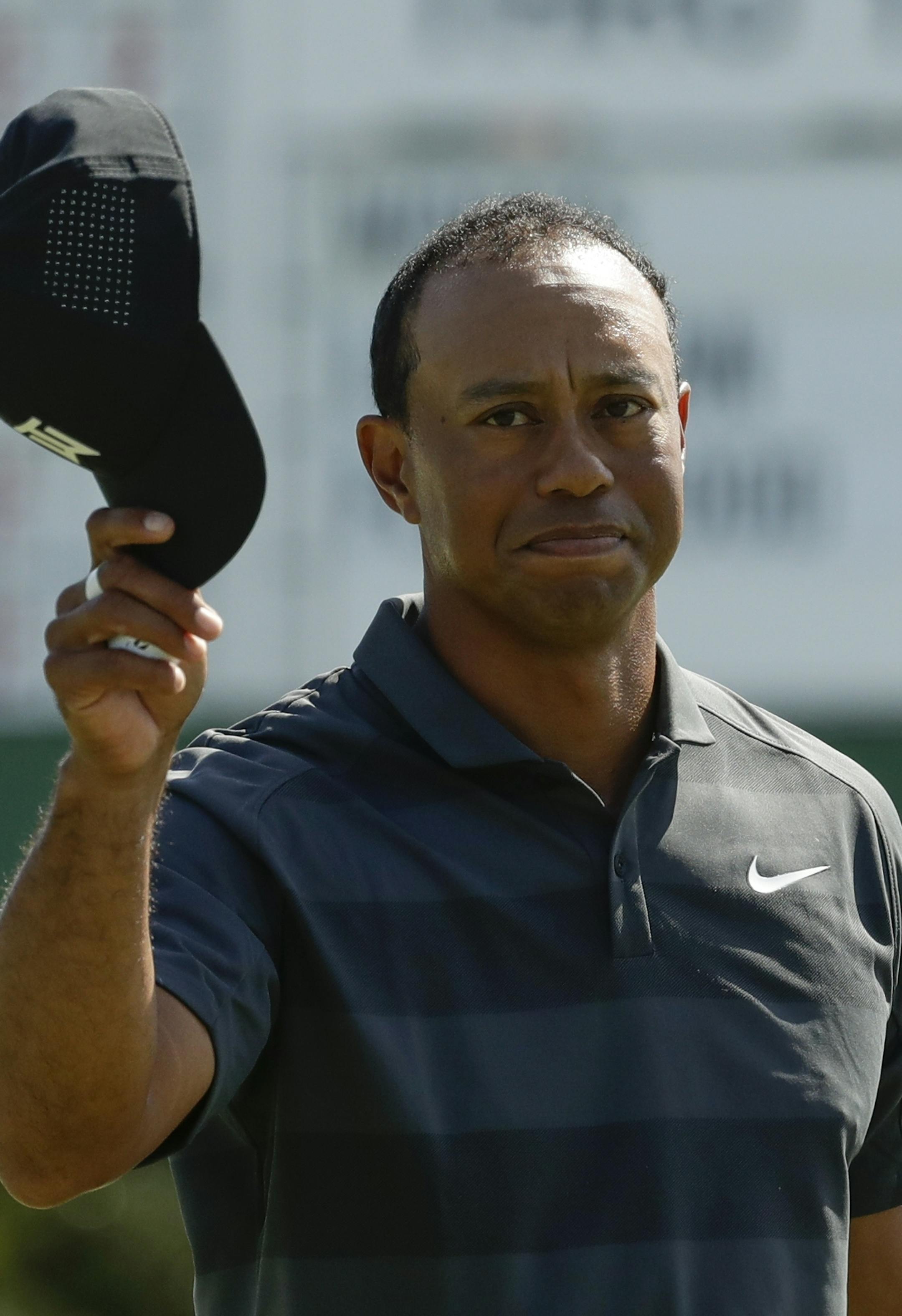 Tiger Woods tips his hat on the 18th hole during the first round at the Masters golf tournament Thursday, April 5, 2018, in Augusta, Ga. (AP Photo/Chris Carlson)